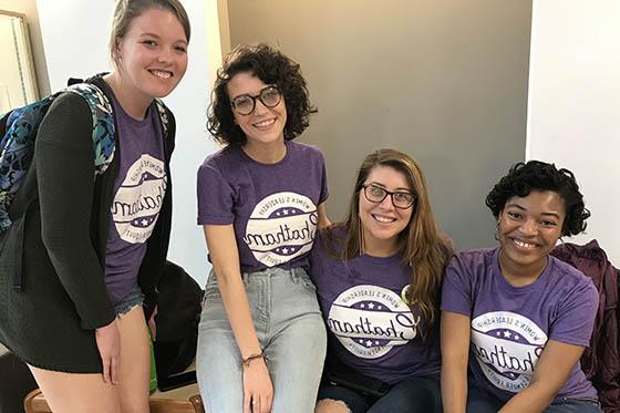 Photo of four Chatham University students wearing Chatham shirts, posing together and smiling