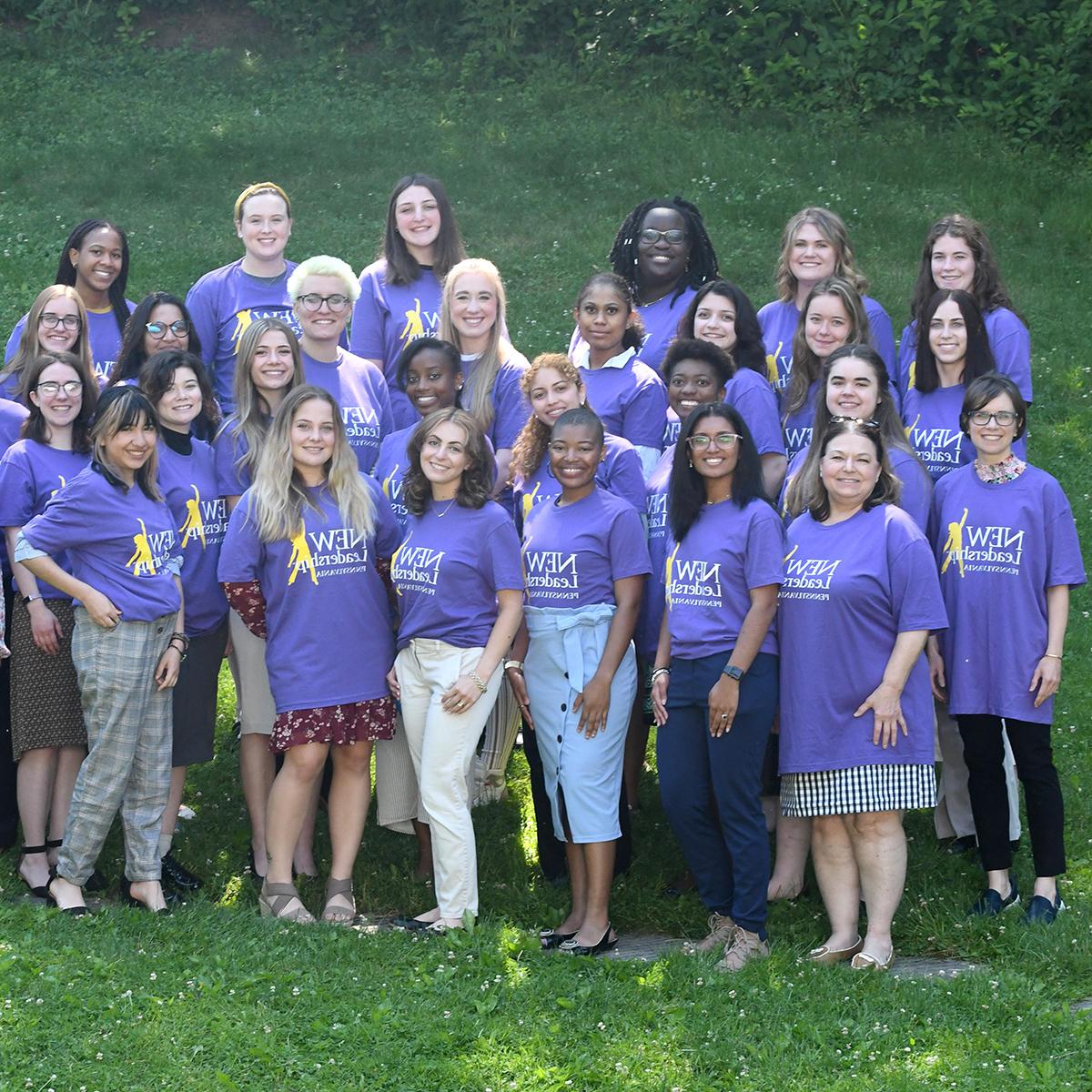 Photo of a group of women in purple NEW Leadership t-shirts posing for a photo outside